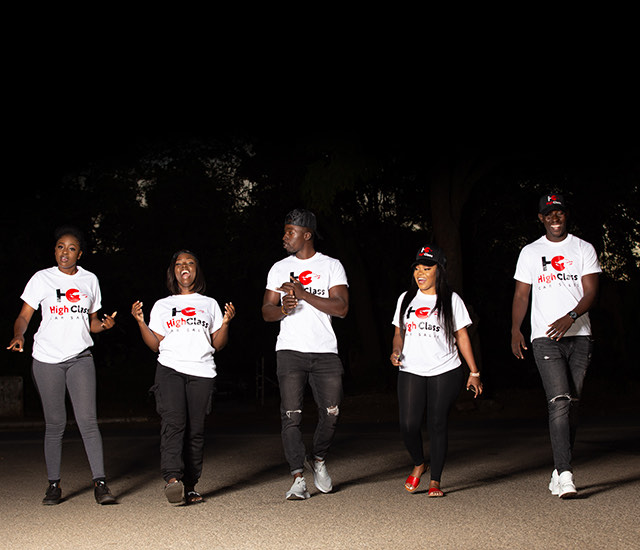 Five High Class Car Sales staff walking together in branded shirts